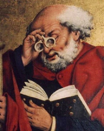Friar Alessandro della Spina using early-form spectacles to read a book.